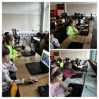 Na zdjęciu dzieci pracują przy komputerach
